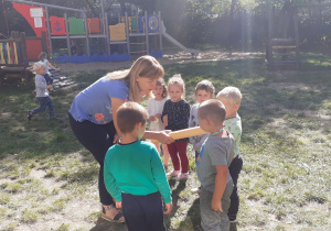 nauczycielka w ogrodzie przedszkolnym pasuje dzieci z grupy I na przedszkolaka